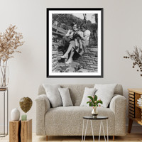 Manuhin at home. Alma, Calif. - Yehudi Menuhin, his wife and son, Krov seated on rock wall near the pool at the estate, Historic Print
