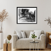 The crew of 105 mm Howitzer, Battery B., 33rd Field Artillery with gun set in Arabic mud-block abode for firing in defense of the Kassserine Pass, North Africa, Vintage Print