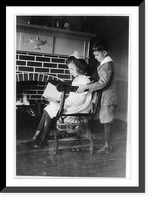 Historic Framed Print, Evora and Porfirio Bonet [looking at book in front of fireplace],  17-7/8" x 21-7/8"