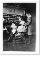 Historic Framed Print, Evora and Porfirio Bonet [looking at book in front of fireplace],  17-7/8" x 21-7/8"