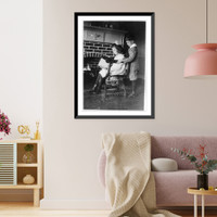 Historic Framed Print, Evora and Porfirio Bonet [looking at book in front of fireplace],  17-7/8" x 21-7/8"