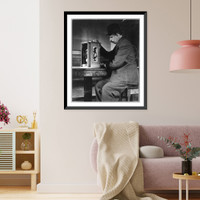 Historic Framed Print, [Man seated with a stamp vending machine],  17-7/8" x 21-7/8"