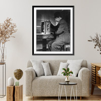 Historic Framed Print, [Man seated with a stamp vending machine],  17-7/8" x 21-7/8"