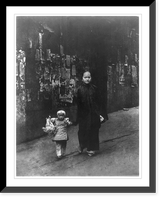 Mother and small daughter walking on sidewalk in Chinatown. San Francisco. Old ragged and faded handbills on wall in background, Vintage Poster