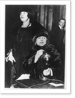 Historic Framed Print, Grand opera by radio inaugurated as regular program of Chicago company. Mary Garden. listening as Miss Edith Mason,. sings into the radio transmitter for the first regular radio program of operas,  17-7/8" x 21-7/8"