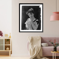 Historic Framed Print, [Young woman, half lgth., with flowers in her hair, holding left hand to chin],  17-7/8" x 21-7/8"