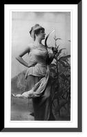Historic Framed Print, [Young woman modeling: 3/4 lgth., standing, facing right, holding sickle; cornstalks in background],  17-7/8" x 21-7/8"