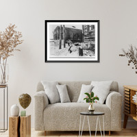 German army in Russia, April 1942: two German soldiers pulling sledge through snowy street, Vintage Wall Art