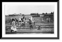 2 women carrying wood for a locomotive in railroad yard at a station north of Petrograd, Russia, Historic Print