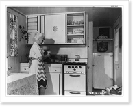 Kitchen of Goodyear Wingfoot prefabricated home with housewife preparing meal, Historic Print