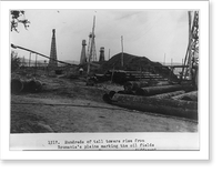 Hundreds of tall towers rise form Roumania's plains marking the oil fields of the country, Antique Print
