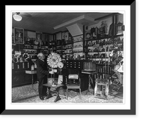 Man with playing cards on pinwheel in a room full of magicians' equipment, Vintage Poster