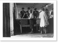 Interior of a cutting shed in Maine. Young cutters at work, Clarence, 8 years, and Minnie, 9 years. Photo does not show the salt water in which they often stand, not i.e., nor? the refuse they ha