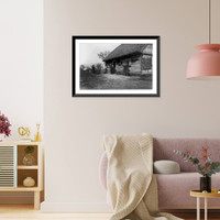 Baskets in front doorway of Polish cottage, with 2 children seated on right and man standing to left, Vintage Print