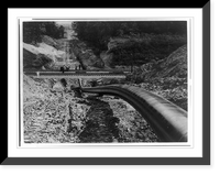 Historic Framed Print, [The Big Inch pipeline under construction: The pipe going under railroad and up hill],  17-7/8" x 21-7/8"