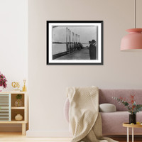 Washington Varsity 8 rowing team posed on dock holding oars, Antique Poster