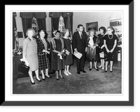 President John Fitzgerald Kennedy, full-length portrait, standing, facing right; with seven women in office in the White House, Antique Poster