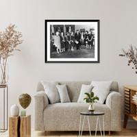 President John Fitzgerald Kennedy, full-length portrait, standing, facing right; with seven women in office in the White House, Antique Poster