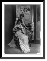 Historic Framed Print, [Miss Jessie Wilson, standing, and Miss Eleanor R. Wilson, seated, reading],  17-7/8" x 21-7/8"