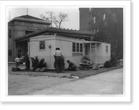 Wingfoot prefabricated home model erected in front of Goodyear Rubber Co., Washington, D.C., with three men planting shrubbery and flowers, Historic Reproduction