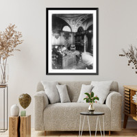 Historic Framed Print, [Side view of Herbert Putnam, Librarian of Congress, seated, full-length portrait, at his desk],  17-7/8" x 21-7/8"