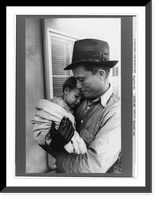 Eleven Mile Corner, Ariz., Feb. 1942. Farm Security Administration migratory workers' community. Father with his baby waiting to see the doctor at the clinic of the Cairn General Hospital Heritage