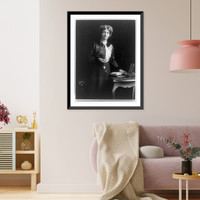 Emmeline (Goulden) Pankhurst, three-quarter length portrait, standing by small table, facing right, with left hand on book, Vintage Print