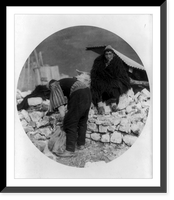 Albanian man in long-haired cape looking in dismay at ruins of his home, caused by an earthquake in Tepelena, Albania. Another man is sorting stones to repair the damage, Vintage Poster