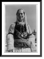 Albanian woman in elaborate dress, half-length, standing, facing left, Vintage Poster