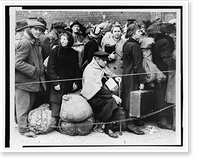 German displaced persons, carrying their few belongings, crowd behind a rope and double strand of barbed wire as they wait in Berlin's Anhalter Station to leave the German capital Timeless Wall A