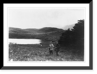 Two men with guns in foreground, pond and mountain in background, taken during the Harriman Alaska Expedition, 1899, Historic Print