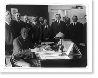 Calvin Coolidge seated at table signing bills, surrounded by group of men, Historic Print