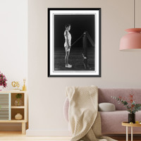 Historic Framed Print, [Gene Tunney, full-length portrait, standing, right profile, lifting weights on pulleys],  17-7/8" x 21-7/8"