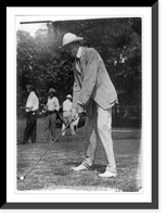Historic Framed Print, [Tuckerman swinging at golf ball, Washington, D.C., area],  17-7/8" x 21-7/8"