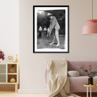 Historic Framed Print, [Tuckerman swinging at golf ball, Washington, D.C., area],  17-7/8" x 21-7/8"