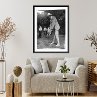 Historic Framed Print, [Tuckerman swinging at golf ball, Washington, D.C., area],  17-7/8" x 21-7/8"