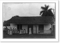Two women and nine children posed standing in front of house and laundry line, Cuba, Vintage Poster