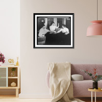 Seance with three women holding hands on table and one of them holding up bell, Historic Print
