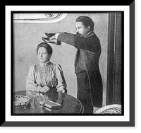 Seance with man holding pair of shoes over head of woman, who is seated at table, Vintage Print