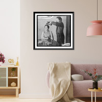 Seance with man holding pair of shoes over head of woman, who is seated at table, Vintage Print