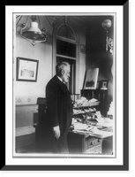 Benjamin Franklin Tracy, three-quarter length portrait, standing by desk, left profile, probably taken while Secretary of the Navy, Vintage Poster
