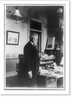 Benjamin Franklin Tracy, three-quarter length portrait, standing by desk, left profile, probably taken while Secretary of the Navy, Vintage Poster