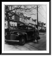 Historic Framed Print, [A Nurse from New York's Henry Street Visiting Nurse Center leaving her car to make a call on a patient who lives in one of the small one-family homes in a typical residential district of a New York suburb],  17-7/8" x 21-7/8"