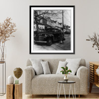 Historic Framed Print, [A Nurse from New York's Henry Street Visiting Nurse Center leaving her car to make a call on a patient who lives in one of the small one-family homes in a typical residential district of a New York suburb],  17-7/8" x 21-7/8"