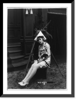 Marvel Rea of Mack Sennett comedy films seated, in front of motion picture camera, full-length portrait, holding puppy, Vintage Poster