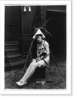 Marvel Rea of Mack Sennett comedy films seated, in front of motion picture camera, full-length portrait, holding puppy, Vintage Poster