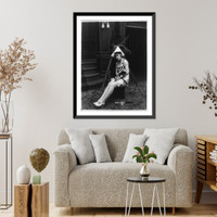 Marvel Rea of Mack Sennett comedy films seated, in front of motion picture camera, full-length portrait, holding puppy, Vintage Poster