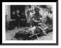 An American soldier wounded by shrapnel is being given blood plasma transfusion by Pfc. Harvey White, Minneapolis, Minnesota, in Sicily, Antique Print