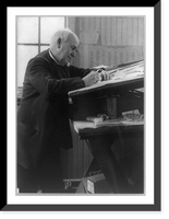 Historic Framed Print, [Thomas Edison, three-quarter length portrait, standing, facing right, writing in his laboratory],  17-7/8" x 21-7/8"