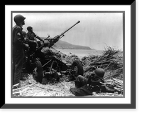 Anti-aircraft Bofors gun dug in at a position on a mound overlooking the beach in Algeria with a U.S. anti-aircraft artillery crew in position Classic, Antique Print